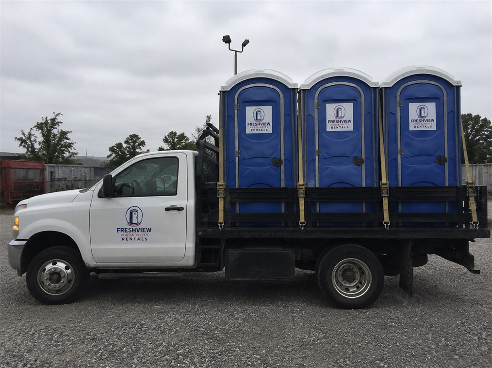Freshview service truck delivering portable restroom units